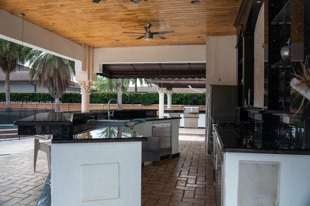 view of patio / terrace featuring sink and ceiling fan