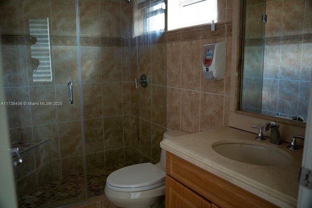 bathroom with vanity, toilet, and an enclosed shower