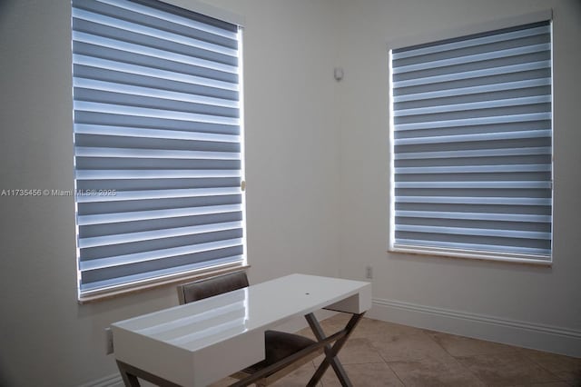 unfurnished office featuring tile patterned floors