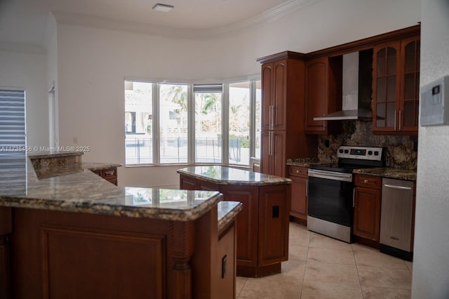 kitchen featuring crown molding, a center island, stone counters, stainless steel appliances, and wall chimney range hood