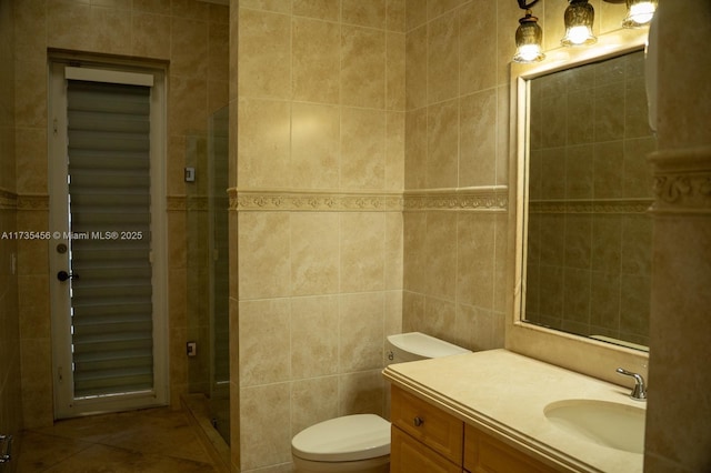 bathroom featuring tile walls, vanity, and toilet