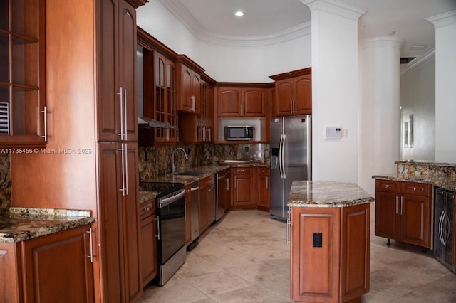 kitchen with stone counters, a kitchen island, sink, stainless steel appliances, and crown molding