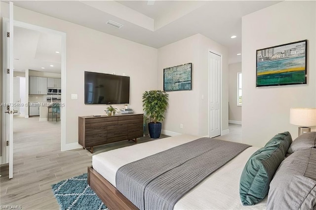 bedroom with a closet and light hardwood / wood-style flooring