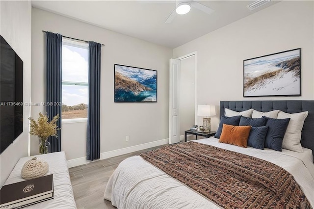 bedroom featuring light hardwood / wood-style floors and ceiling fan