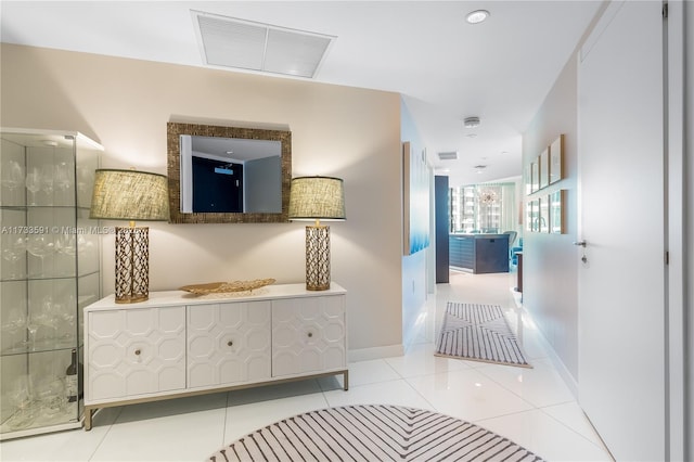 hall featuring light tile patterned floors