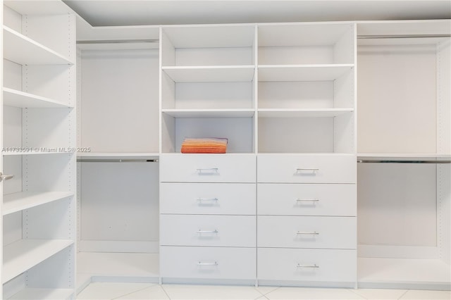 spacious closet featuring light tile patterned floors