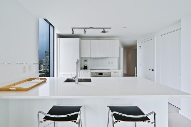 tiled living room featuring floor to ceiling windows