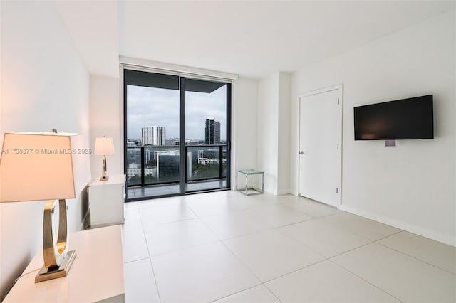 unfurnished living room featuring expansive windows and light tile patterned flooring