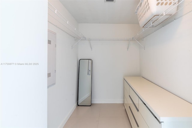 walk in closet with light tile patterned floors