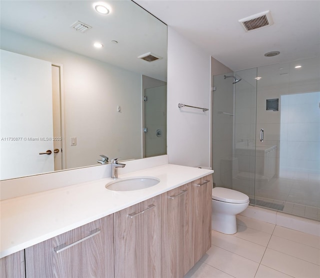 bathroom with walk in shower, vanity, toilet, and tile patterned flooring