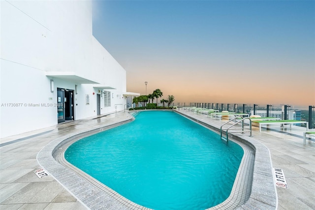 view of pool at dusk