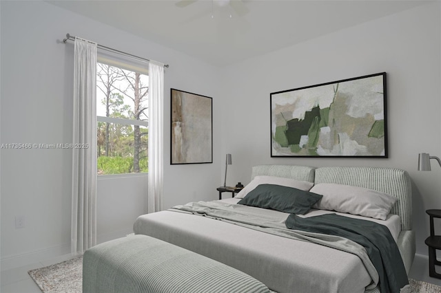 bedroom featuring ceiling fan and multiple windows