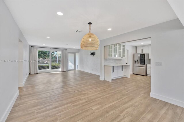 unfurnished living room featuring light wood-type flooring