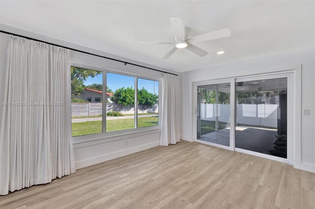 unfurnished room with ceiling fan and light wood-type flooring