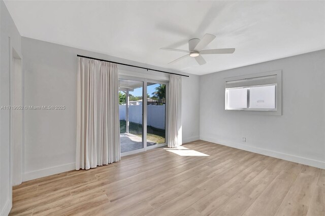 empty room featuring ceiling fan and light hardwood / wood-style flooring