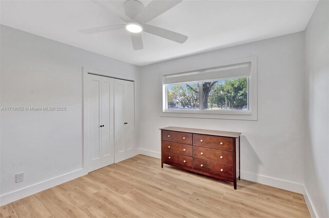 unfurnished bedroom featuring a closet, ceiling fan, and light wood-type flooring