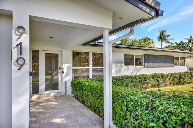 doorway to property featuring a patio area