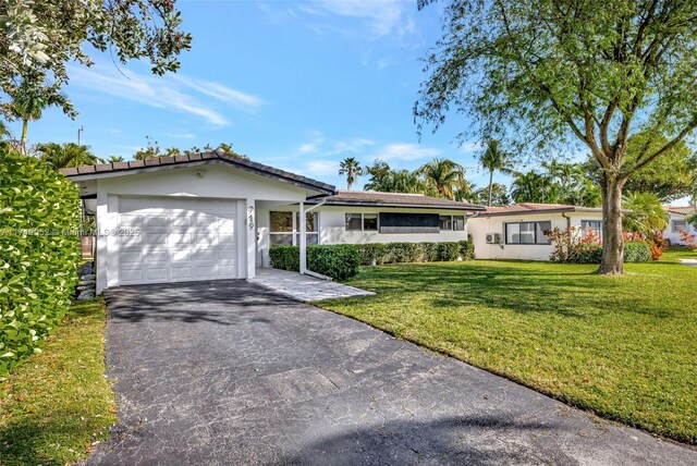 ranch-style house with a garage and a front lawn