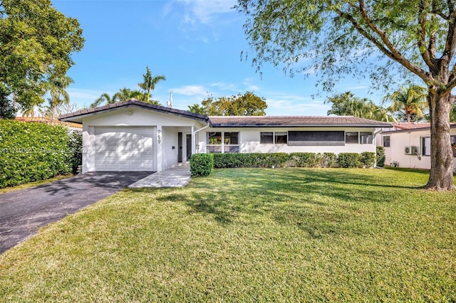 ranch-style home with a garage and a front yard