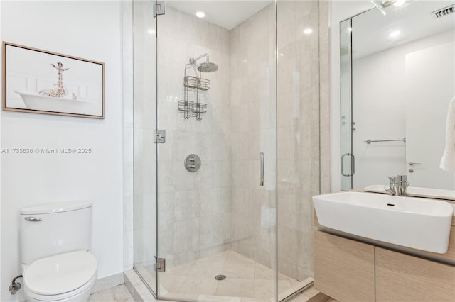 bathroom featuring walk in shower, vanity, and toilet