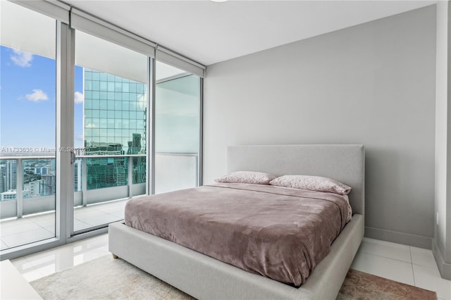 tiled bedroom featuring expansive windows and access to outside