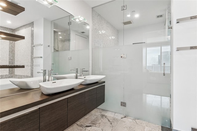 bathroom featuring vanity and a shower with door