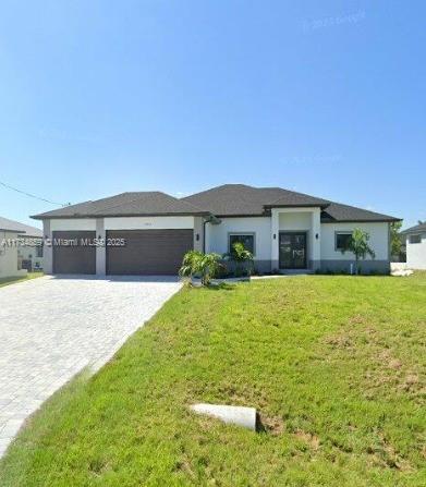 prairie-style home with a garage and a front yard