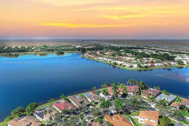 aerial view at dusk with a water view