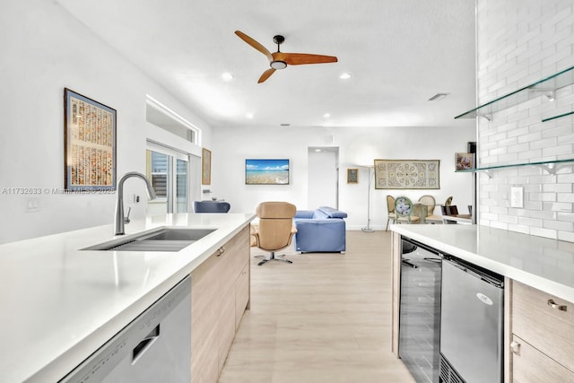 kitchen with light brown cabinetry, sink, beverage cooler, ceiling fan, and stainless steel appliances