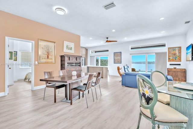 dining room with ceiling fan and light wood-type flooring