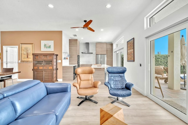 living room with light hardwood / wood-style flooring and ceiling fan