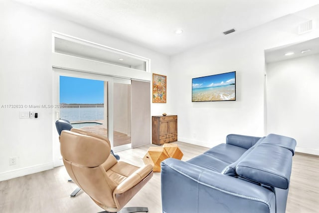 living room with light hardwood / wood-style flooring