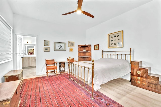 bedroom featuring hardwood / wood-style flooring and ensuite bathroom