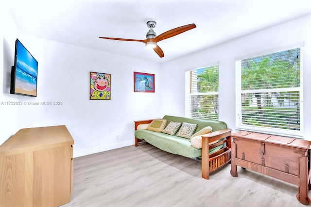 sitting room featuring wood-type flooring and ceiling fan