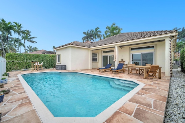 view of pool featuring central air condition unit and a patio area