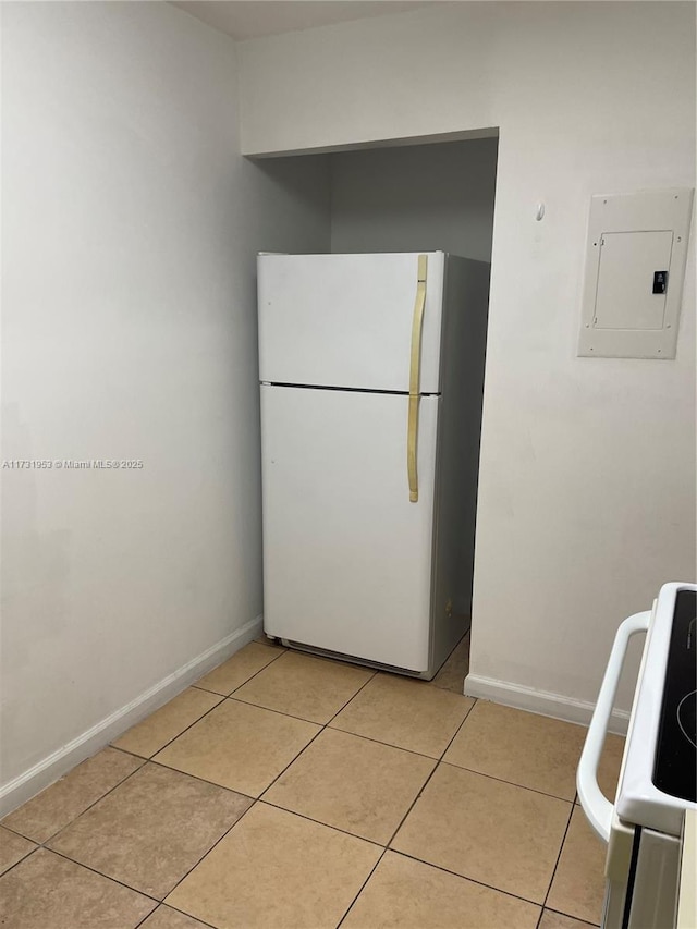 kitchen featuring light tile patterned floors, electric panel, and white appliances