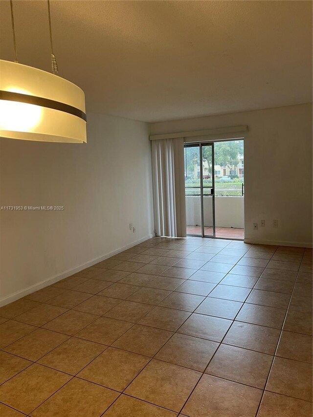 unfurnished room featuring light tile patterned flooring