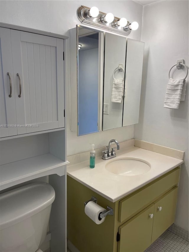 bathroom featuring vanity and toilet