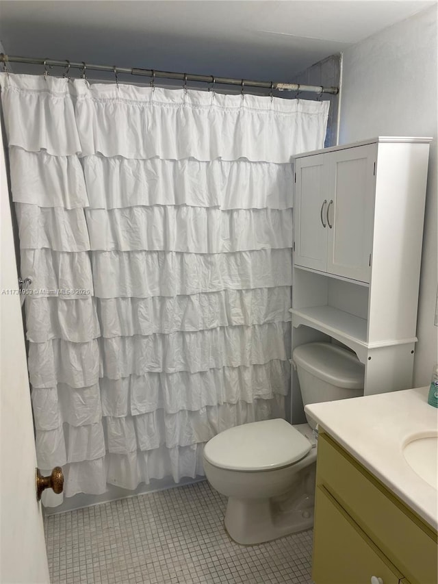 bathroom with vanity, toilet, and tile patterned flooring