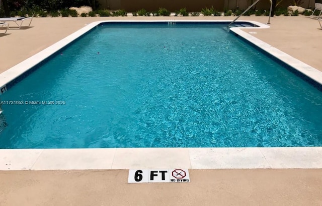 view of swimming pool with a patio area