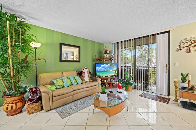 tiled living room featuring a textured ceiling