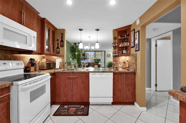 kitchen with sink, decorative light fixtures, light tile patterned floors, white appliances, and decorative backsplash