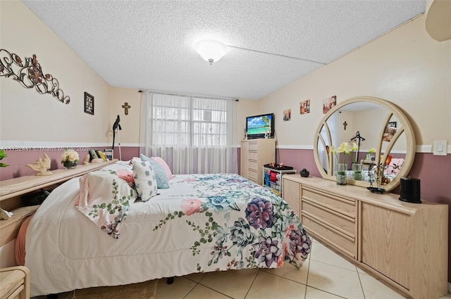 tiled bedroom with a textured ceiling