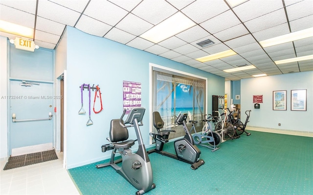 exercise room featuring a drop ceiling