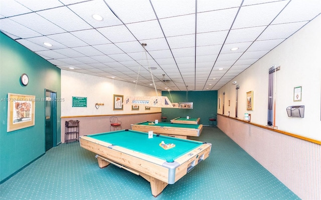 rec room featuring carpet floors and a paneled ceiling