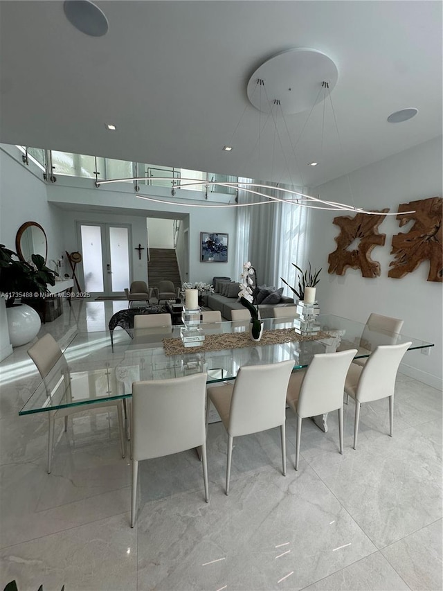 dining space featuring french doors and a healthy amount of sunlight