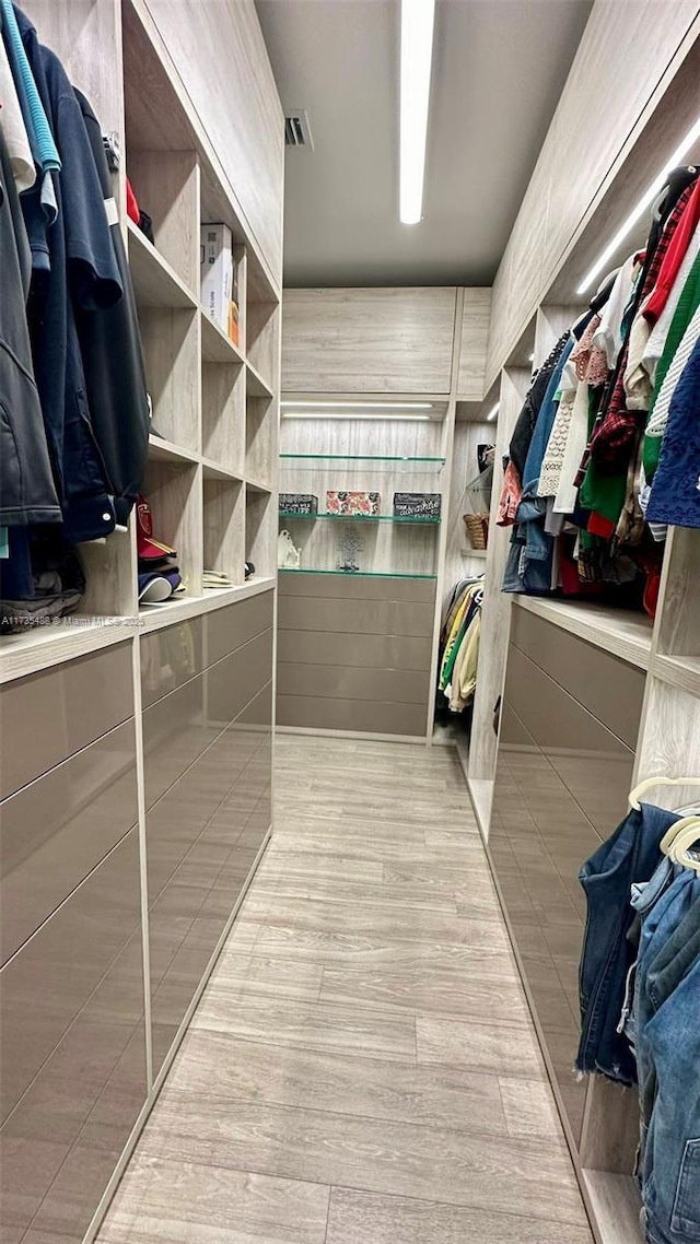 spacious closet featuring light wood-type flooring