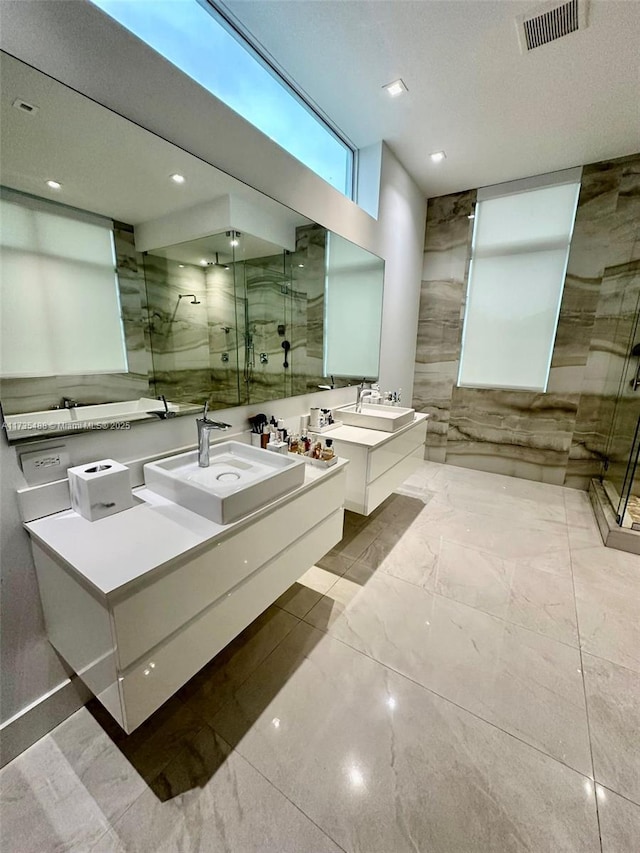 bathroom featuring vanity and a shower with shower door