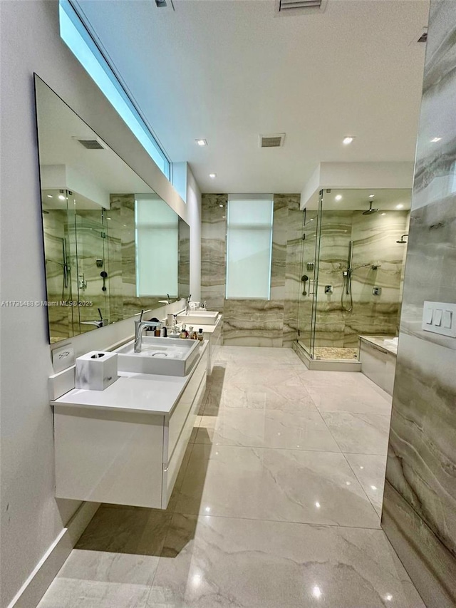 bathroom featuring vanity and a shower with shower door