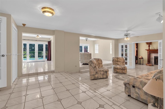 unfurnished living room featuring a healthy amount of sunlight, a fireplace, and french doors